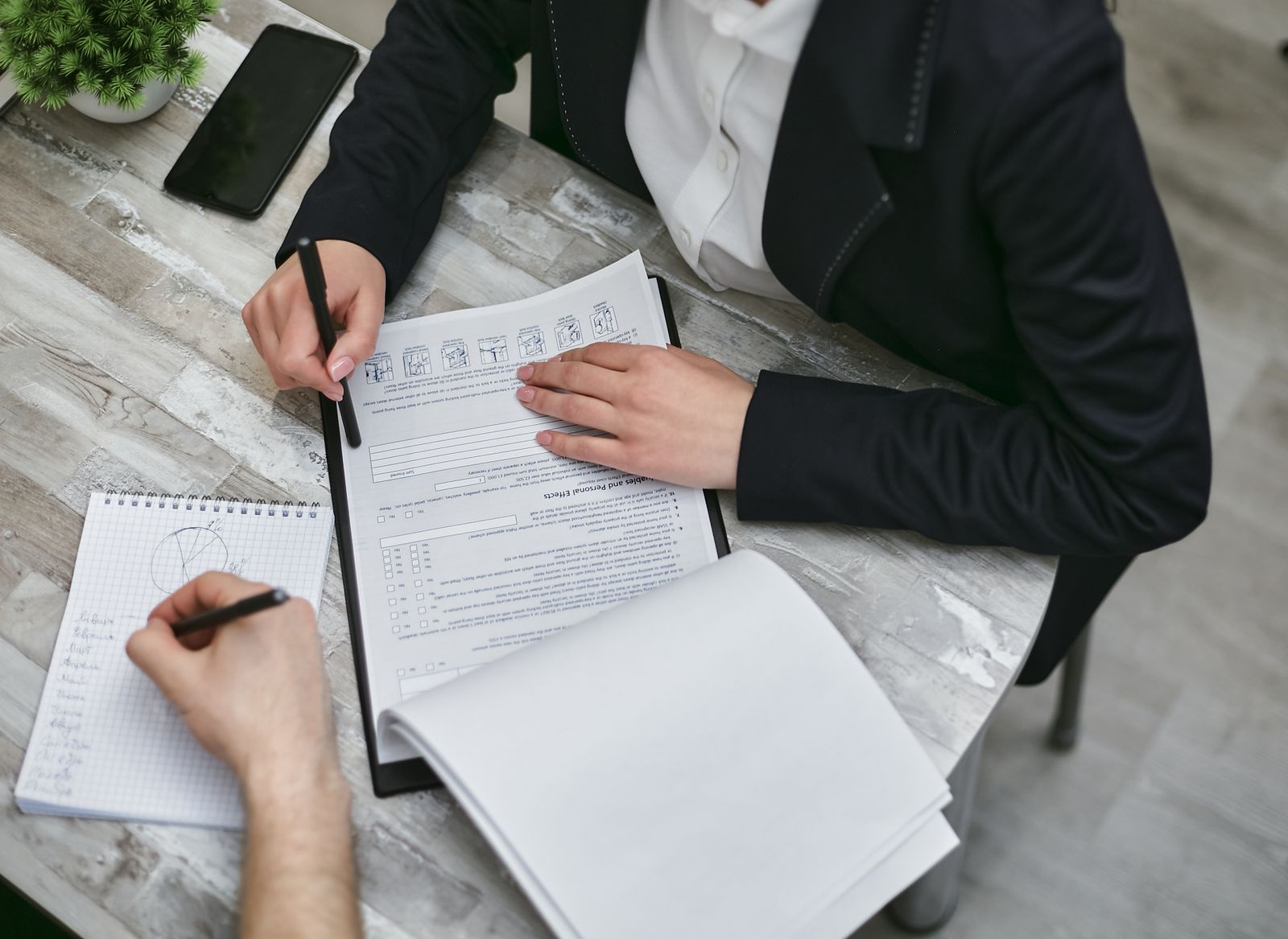Two people reviewing a report at a desk